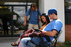 Sophomores (front to back) Spencer Thibodeaux, nursing major from St. Martinville, and Sarah Legendre, nursing major from Raceland study in the smoke-free area outside of Gouaux Hall as Blake Terry, pre-engineering major from Lockport, unchains his scoote