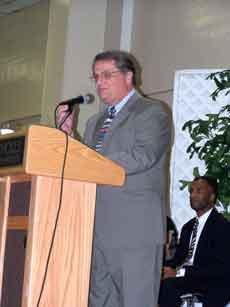 State Senator "Butch" Gautreaux gives a speech on how he got into public service, and what he thought public service should mean to others as Assitant District Attorney Roger Hamilton Jr. sits back and listens.