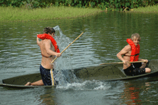 Kevin Griffin, nursing junior from Galliano, gets a splash from his teammate Rory Russel, freshman from Franklin, during the pirogue races held on Tuesday. 