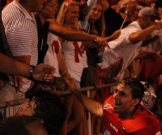 Freshman defensive back Justin Arbuckle shakes hands with fans after Saturday nights win against the Southeastern Lions 14-10.