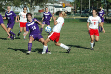 Freshman midfielder Jessica Bedford, attempts to steal the ball from a Stephen F. Austin player as junior midfielder Jessica Schwartz and freshman center/midfielder Alicia Gautreau run to support her.