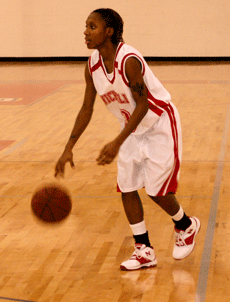 Katherine Plummer, junior point guard, dribbles the ball during the game against the  Central Arkansas Sugar Bears Saturday afternoon in Stopher Gym.