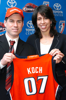 Hilton Koch, owner of the Houston-based Hilton Furniture chain, receives a Houston Comets jersey bearing his name from WNBA president Donna Orender, marking Kochs purchase of the womens basketball team Jan. 31 in Houston. 