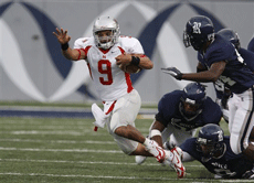 Junior quarterback Vincent Montgomery runs by Rice defenders during the first quarter of the football game at Rice Stadium Sept. 1 in Houston. Nicholls went on to win 16-14 after the game was delayed twice by lightning.