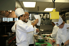 Mathew Whipple, dietetics senior from Austin, Texas,  asks Chef Randy Cheramie questions about a recipe.