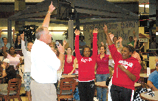 Head football Coach Jay Thomas excites the crowd during the pep rally held in the Bollinger Memorial Student Union Wednesday. Homecoming events continue this week.