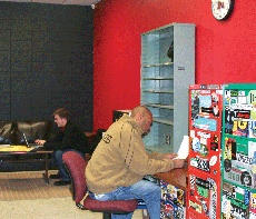 Station manager Joshua McKnight, mass communication senior from Thibodaux (foreground), and Justin Bourgeois, mass communication sophomore from Raceland, sit in the newly painted KNSU office Wednesday. 