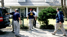 FBI agents search a house in Houma Monday, Feb. 11 as part of an investigation into former businessman and Nicholls alumnus Tai Kuo, who is accused of forwarding classified defense information from weapons systems policy analyst Gregg W. Bergersen to the 