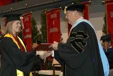 Lauren Leblanc, biology summa cum laude from Lutcher, receives her degree from University President Stephen Hulbert May 17 in Stopher Gym.