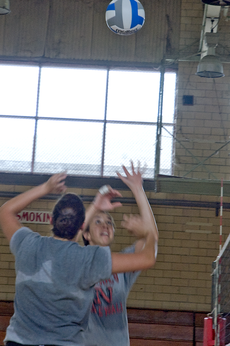 Outside hitter Rachel Spreen sets up a shot for freshman Casie Blanchard during a practice.