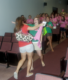 Stacy Goss, business senior from Houma, and the rest of Delta Zeta sorority welcome one of their new members during recruitment last week.