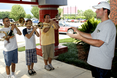Pride of NSU Drum Major David LeCompte, right, practices a song with band members on Monday.