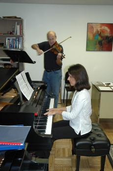 Violinist James Alexander, adjunct instructor of music, and pianist Luciana Soares, assistant professor of music - both artists in residence at Nicholls - practice for their Kennedy Center performance.