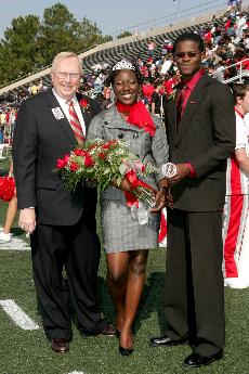 University President Stephen Hulbert congratulates Homecoming Queen Marquita Hill, family and consumer science senior from Boutte, and King Ugochukwu Ugo Ezema, biology senior from Kingston, Jamaica.