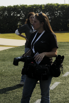 Newly hired campus photojournalist Misty McElroy prepares to take photos at the Nov. 1 Homecoming football game in Guidry Stadium.