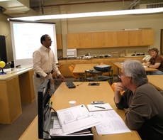 Balaji Ramachandran, assistant professor of applied sciences, talks to students in his Geomatics 305 class in Gouaux Hall Monday.