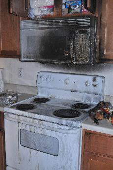 The stove and microwave inside room 716 of La Maison du Bayou was damaged by a fire Monday. An unattended pot on the stove caused the fire.