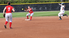Nicholls third baseman Kayla Watterson and second baseman Danielle Clayton try to turn a double play during the Southeastern game at the Nicholls Softball Complex.