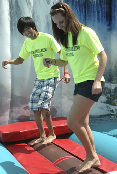 Phong PH Troung, accounting graduate from Vietnam, and Megan Pelloquin, culinary arts graduate from Carencro, try the Rolling Log Ride at a previous Welcome Back Day.