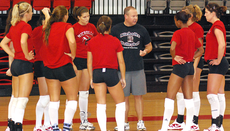 Volleyball head coach Chris Laird explains the next play to the volleyball team during practice in Stopher Gym last week.