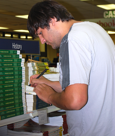  Ross Todd, history sophomore from Thibodaux, checks off books from his list before the start of school.