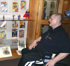 Comic book enthusiast Daniel Lirette looks at his collection, which is currently on display in the Ellender Memorial Librarys archives, last Wednesday.