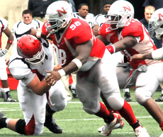 Senior defensive lineman Quenton Mims (98) and junior defensive lineman Marquis Russell (87) meet the Duquesne offensive line head-on during Saturdays game.  The Colonels won 14-7.