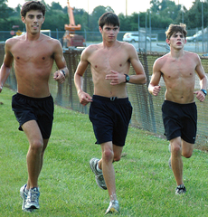 (From left) Distance runners freshman Jordan Reed, sophomore Joseph Fryou and freshman Dylan Williams practice Tuesday.