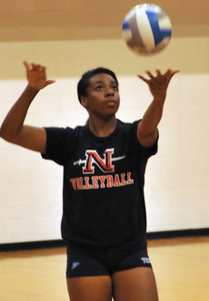 Freshman middle blocker Jasmine Harris prepares to serve the ball during practice.