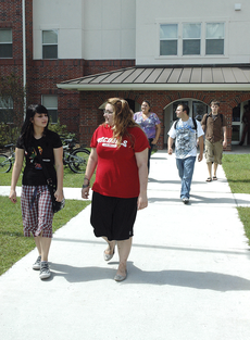 Students walk out of Scholars Hall, one of the on-campus housing options for Nicholls students. On-campus housing is almost filled to capacity this semester.