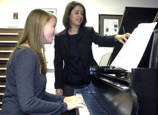 Assistant Professor of Music Luciana Soares helps Kristen Robichaux, music education junior from Thibodaux, practice playing the piano Wednesday in Talbot Hall.