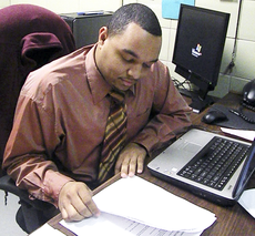 Assistant Director of the Student Union and Student Programming Association adviser Melvin Harrison looks at paperwork in his office Thursday in the Student Unions Student Life department.