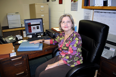 Dolly McGeever, secretary for the Student Government Association, displays the SGA website and meeting minutes Wednesday in her office.