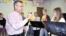 Gregory Torres, instructor of music and director of bands, listens to students in his Arts in Education class practice on their recorders last semester in Talbot Hall.