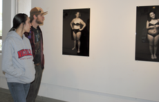 Mallory Fulkerson, marketing senior from Houma, and Gregory Hayes, art freshman from Schriever, visit the Ameen Art Gallery Friday to view photographer Natalie Picketts series Defining Beauty, which portrays women of all sizes to show the individuality