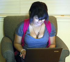 Brooke Simon, nursing sophomore from Slidell, works on her laptop Monday in her La Maison du Bayou apartment.