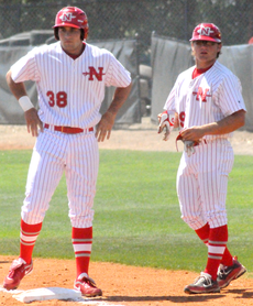 Student assistant coach Josh Swenson, right, stands with redshirt sophomore first baseman Blake Bergeron during Sundays game against Lamar University.