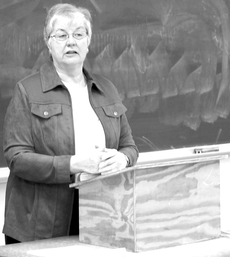 Anita Tully, distinguished service professor of English and assistant dean of the College of Arts & Sciences, lectures in her Literary Topics II class in Peltier Hall.