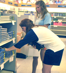 Katie Peterson, pre-medicine junior from Houston, and Michaela Gaudin, family and consumer sciences sophomore from Gonzales, retrieve the necessary textbooks from the Bookstore at the beginning of the fall semester.