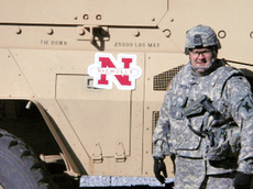 Col. Jacques Thibodeaux stands in front of his MRAP military vehicle where he displays a Nicholls car magnet.