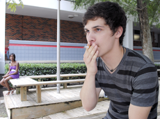 Joseph Calder, safety technology freshman from Houma, smokes outside of the Student Union on Wednesday