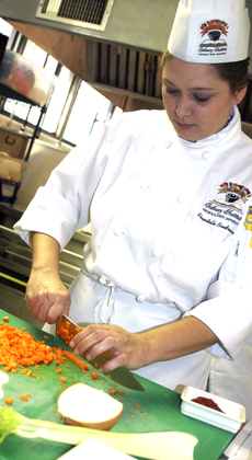 Shantelle Boudreaux, culinary arts sophomore from Golden Meadow, chops carrots during a class last year in Gouaux Hall.