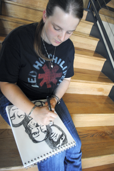 Heather Verret, art education freshman from Centerville, sketches in Millet Hall after class.