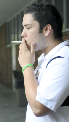 Aaron Day, biology sophomore from Gray, smokes outside the Student Union on Monday.