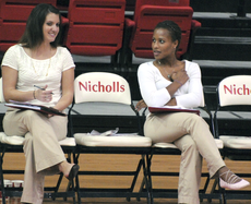 Assistant volleyball coaches, Nicole McCoy and Jaye Loyd, talk during Saturdays game against Louisiana Tech.