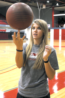 Ashley Adams spins a basketball on her fingertip Tuesday in Stopher Gym.