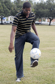 Nnamdi Ezema juggles a soccer ball Monday by Ellender Memorial Library.
