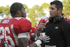 Defensive coordinator and linebacker coach Jeremy Atwell talks with senior linebacker Ed James.