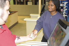 Student union employee Brady Chiasson helps Cierra Vallery, freshman from New Orleans, make a purchase on Tuesday.