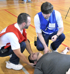 Nursing students help a seizure patient during the disaster simulation.